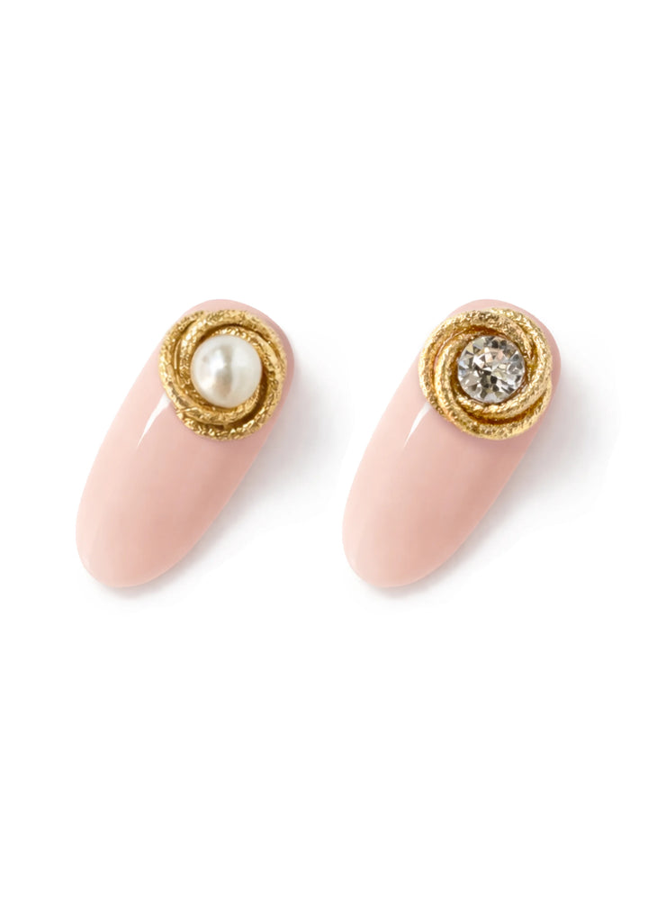 Signature Line Frost brass nail accessories with pearl and crystal on nail tips.